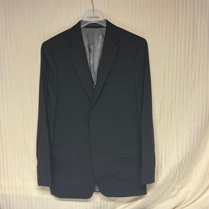 Men’s black Calvin Klein suit.